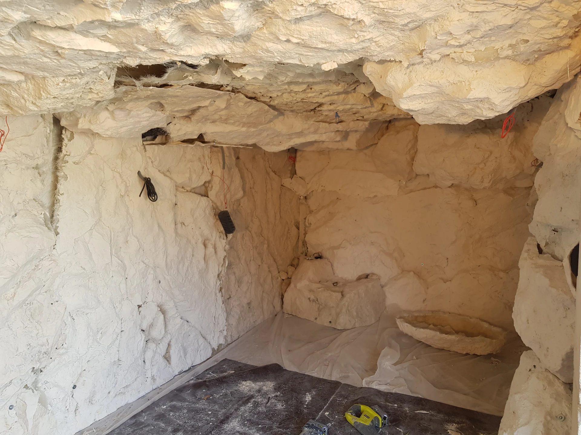 Grotte artificielle intérieure en cours de réalisation – faux rochers polyester habillage mural et plafond imitation cavité rocheuse naturelle